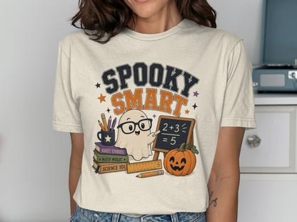 T-shirt graphic: "Spooky Smart" text, ghost with glasses teaching math, pumpkin, and books.