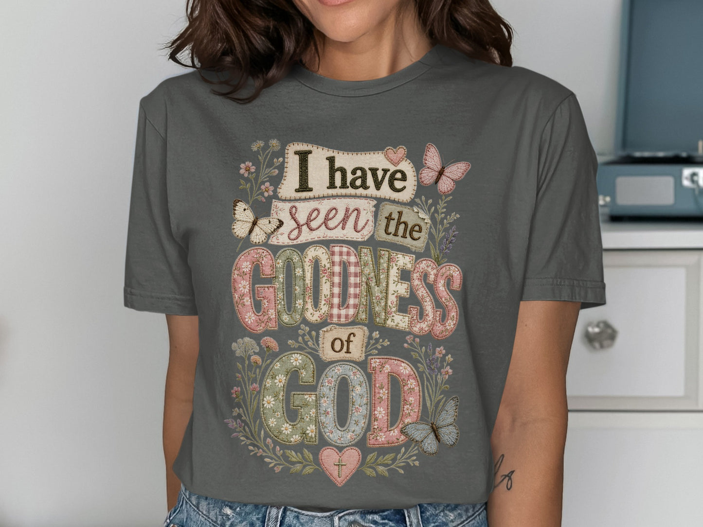 Dark gray t-shirt with "I have seen the goodness of God" in patchwork text.