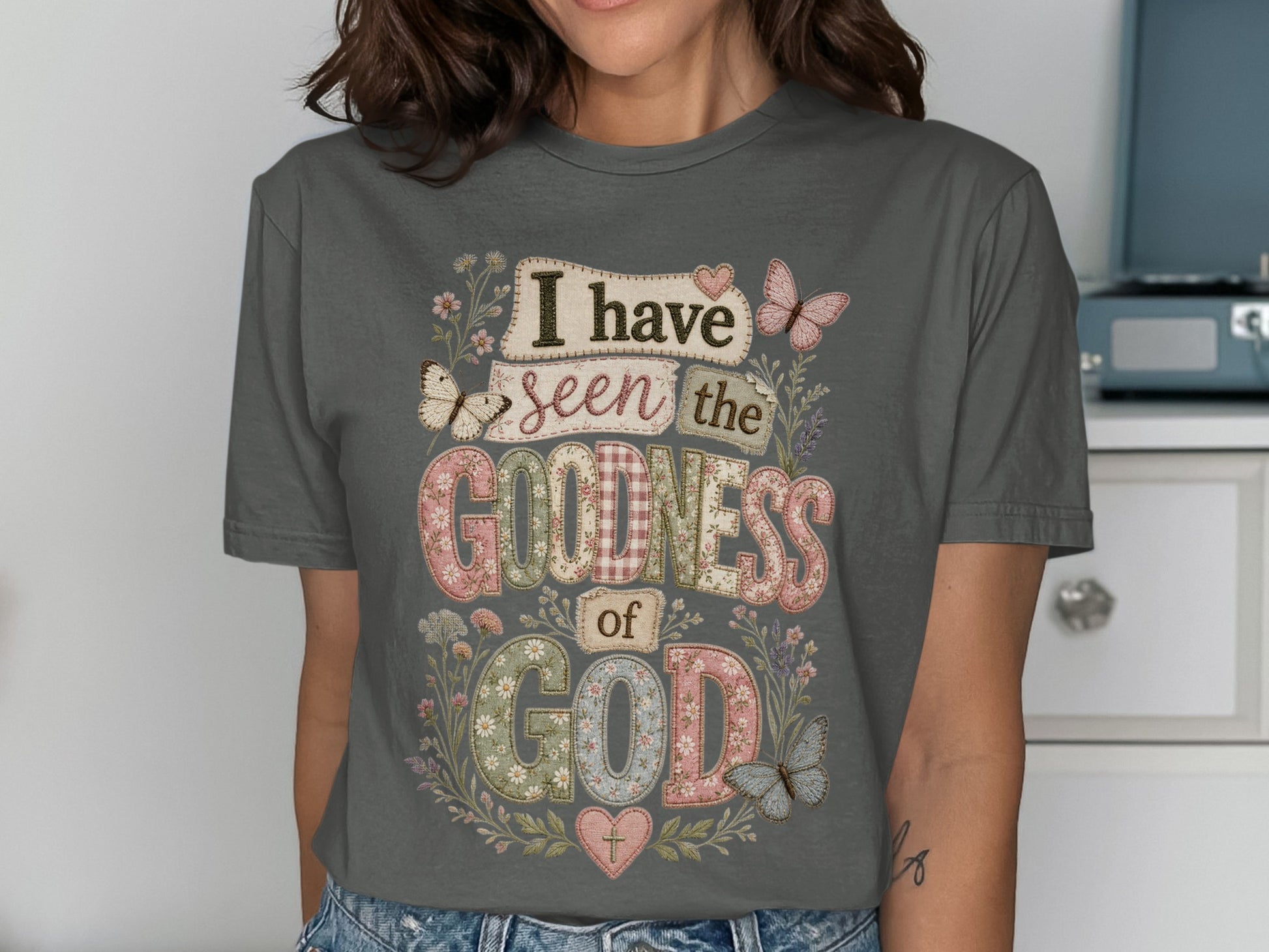 Dark gray t-shirt with "I have seen the goodness of God" in patchwork text.