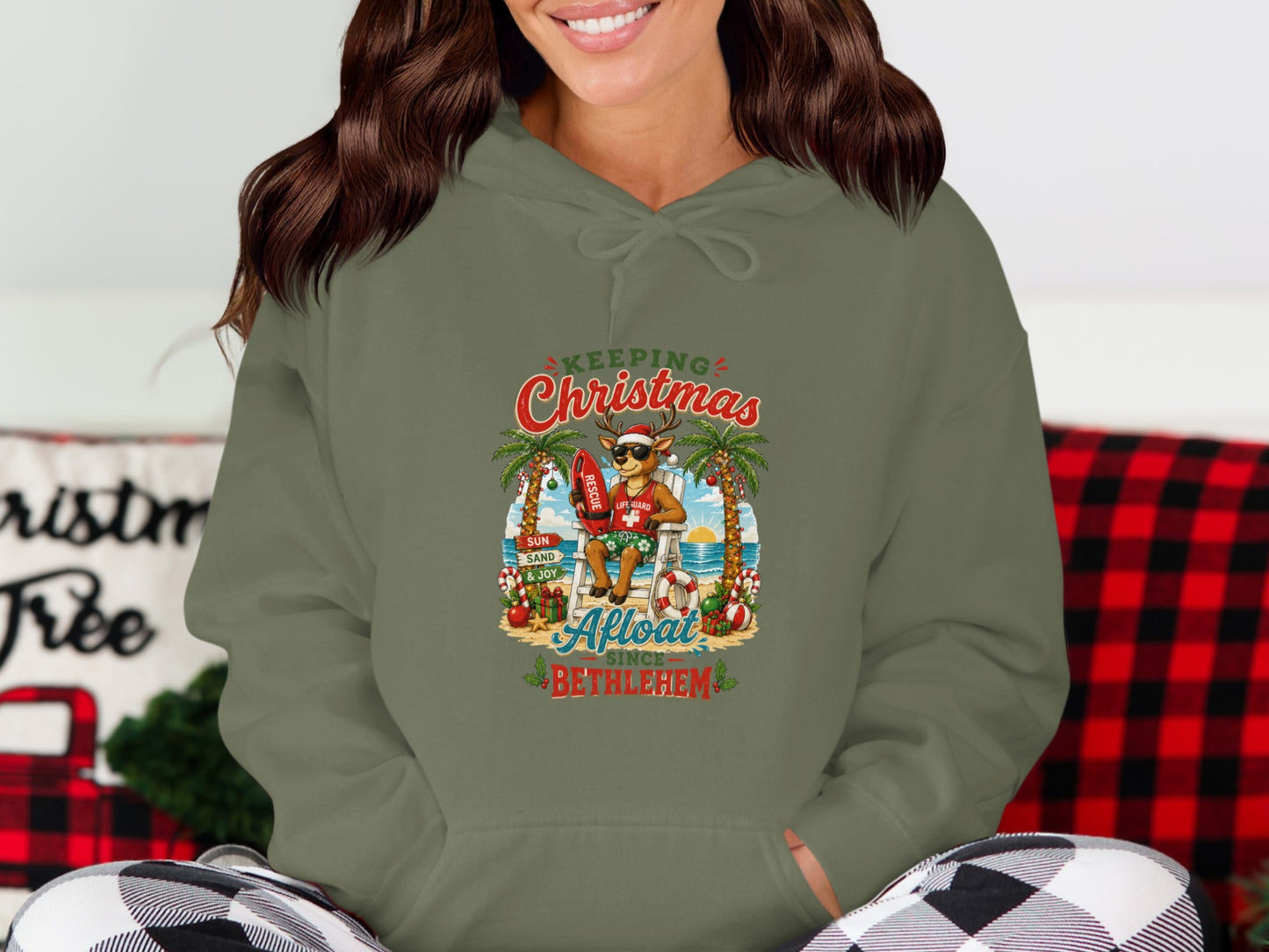 Hoodie with a Christmas lifeguard graphic on a beach.