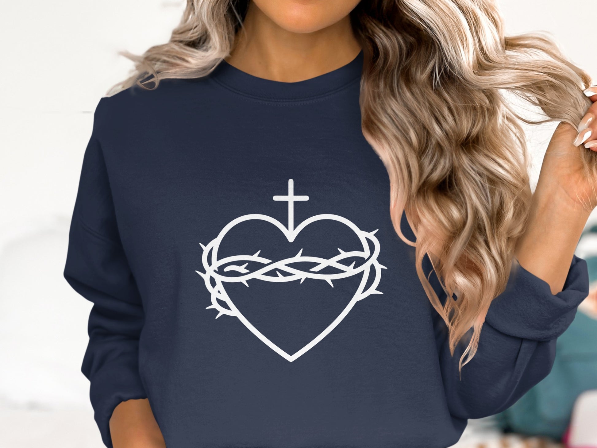 Navy sweatshirt with a white Sacred Heart of Jesus graphic.