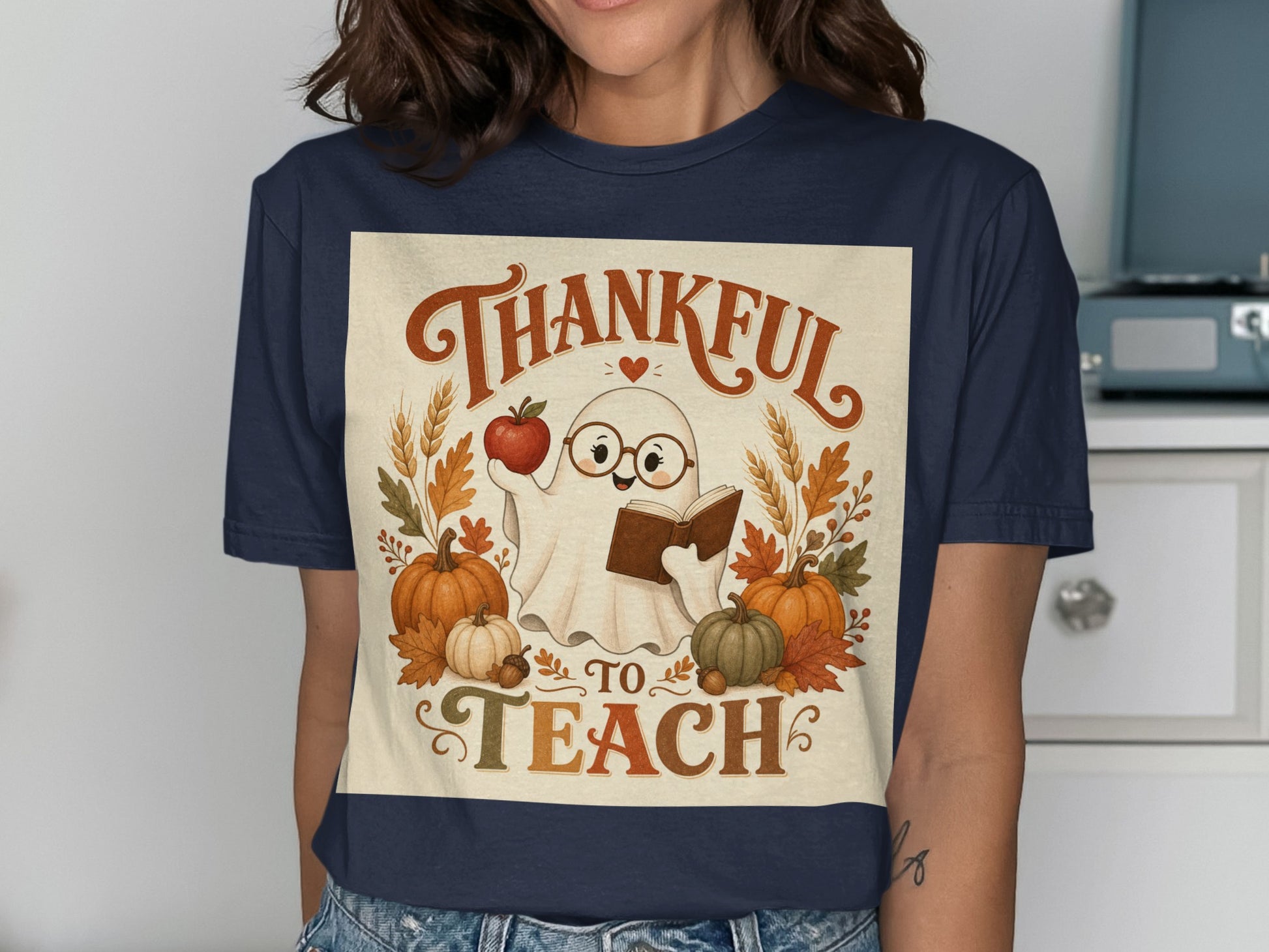Ghost with glasses holds apple and book, saying "Thankful to Teach".