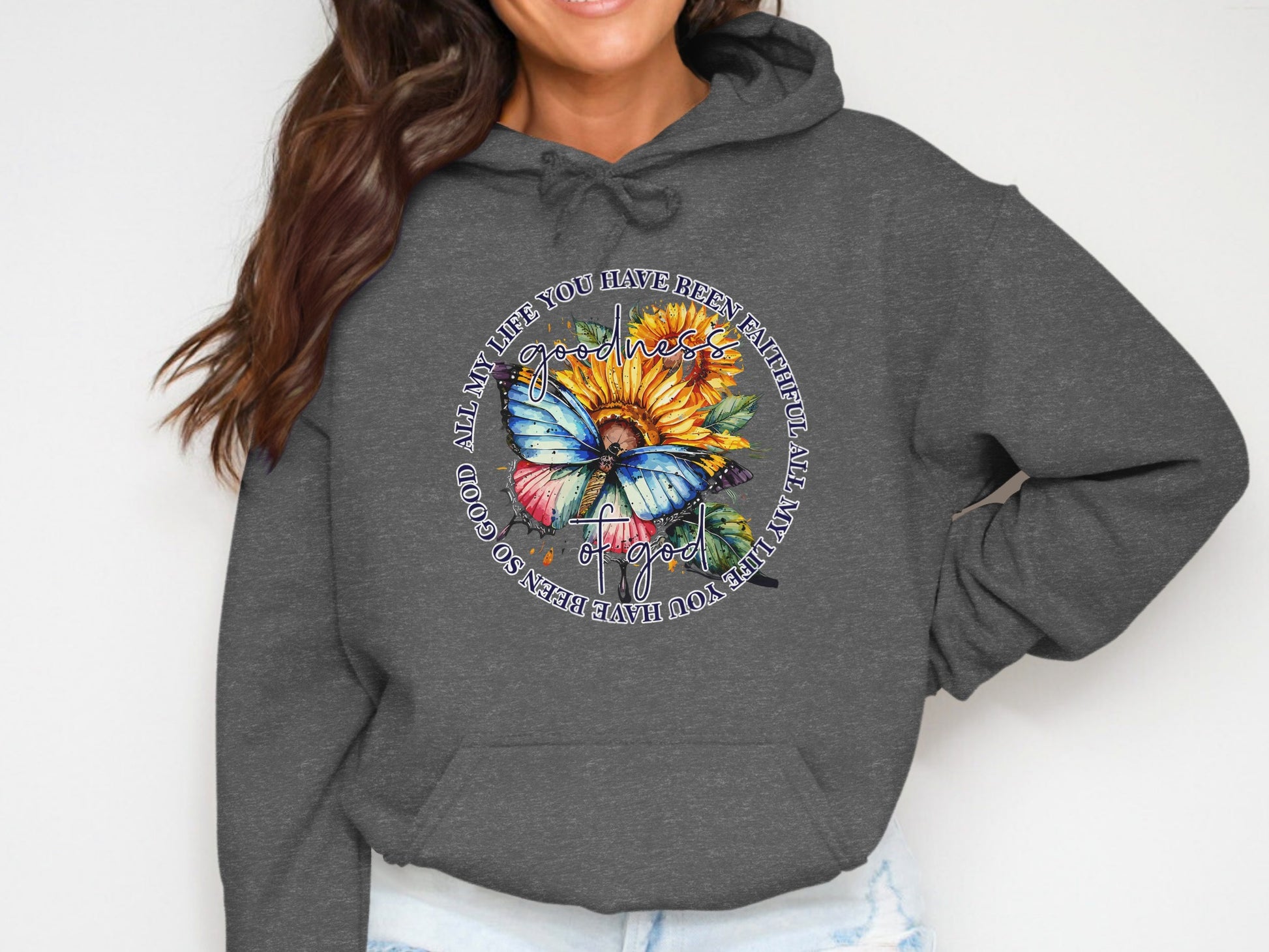 Sunflower and butterfly design with "Goodness of God" text on a dark grey hoodie.