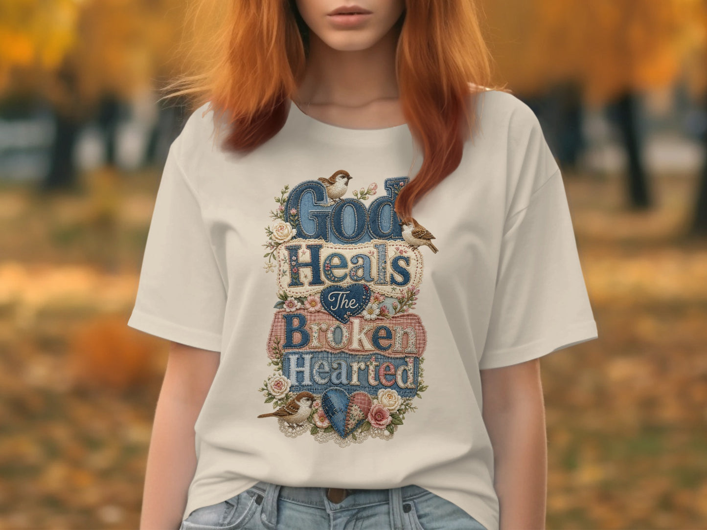 White t-shirt with "God Heals the Broken Hearted" floral and bird graphic.