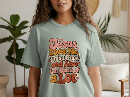 Pale green t-shirt with text "Jesus Loves Me, This I Know and Also I'm Kind of a Lot".