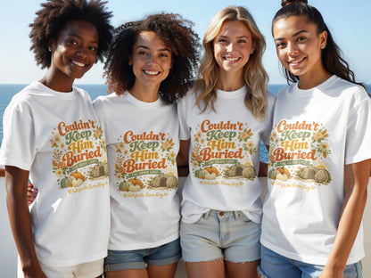 Four women smile wearing white t-shirts with "Couldn't Keep Him Buried" design.