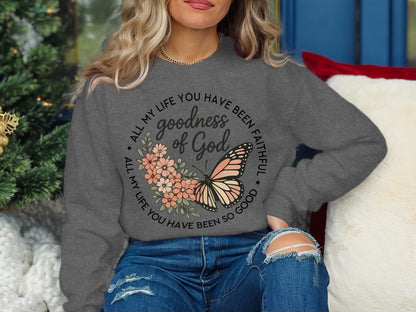 Gray sweatshirt with butterfly and "Goodness of God" text.