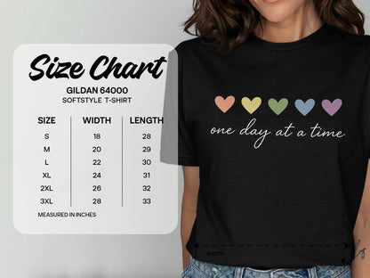 Gildan 64000 Softstyle T-shirt size chart with hearts and "one day at a time" text.