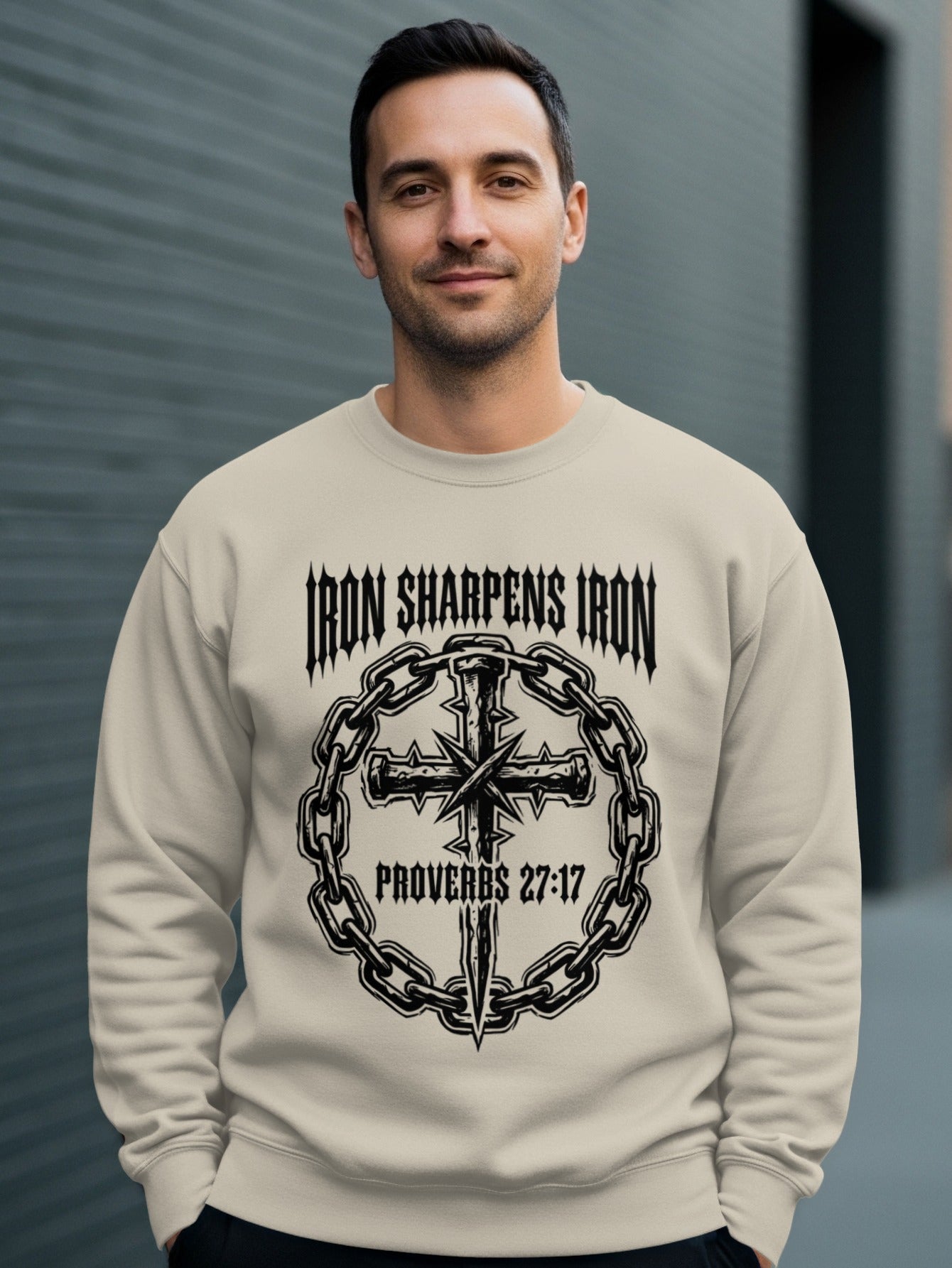 Crewneck sweatshirt with "Iron Sharpens Iron Proverbs 27:17" and a cross.