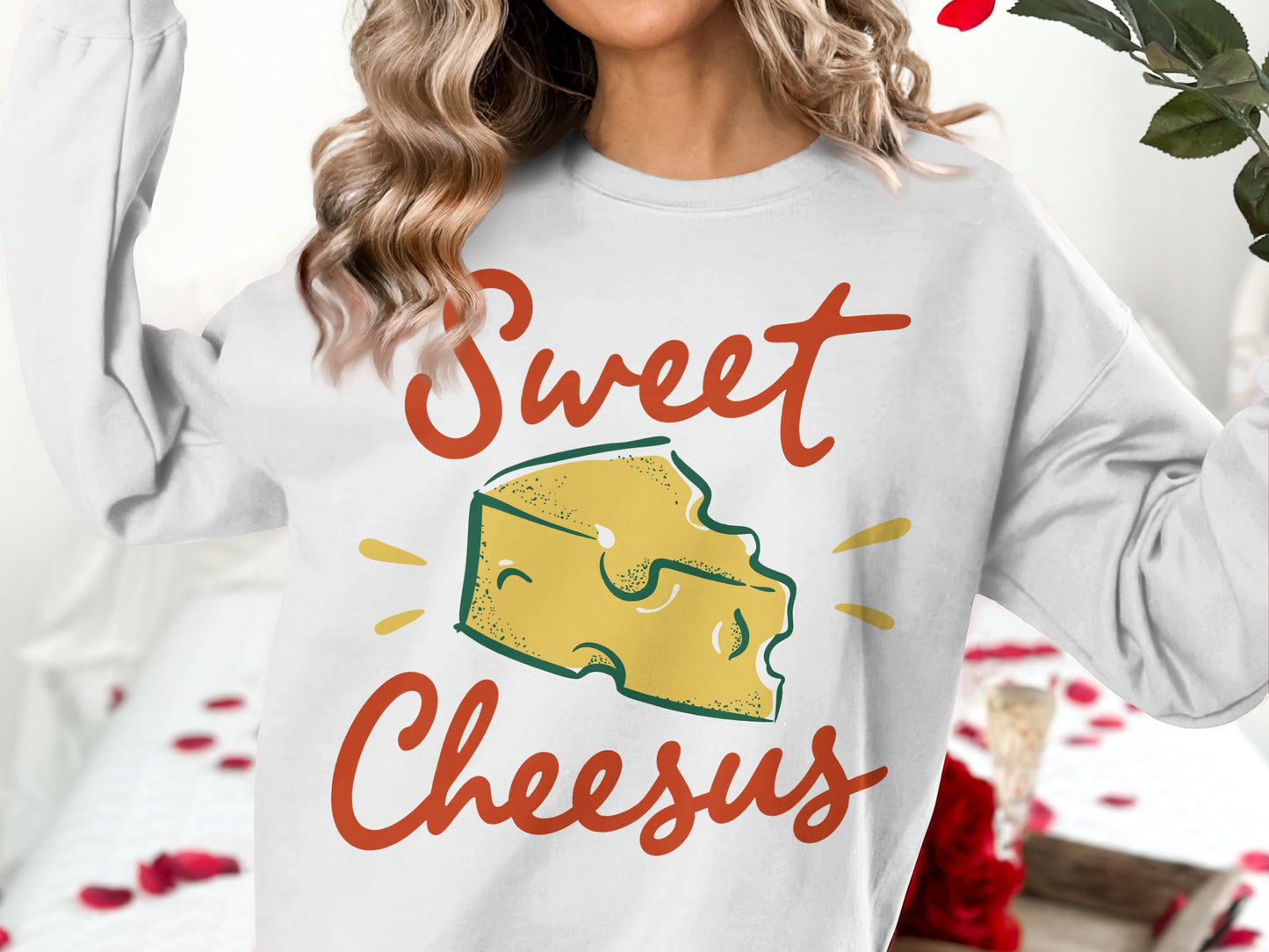 White sweatshirt with "Sweet Cheesus" text and cheese graphic.