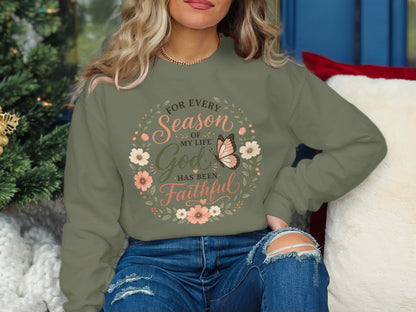 Olive sweatshirt with floral wreath and butterfly, reading "For every season of my life God has been faithful."