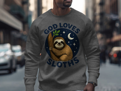 Gray sweatshirt with a graphic of a smiling sloth on a branch, moon, and stars, text reads "God Loves Sloths".