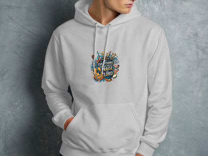 White hoodie with colorful musical instruments and "Praise the Lord" text graphic.