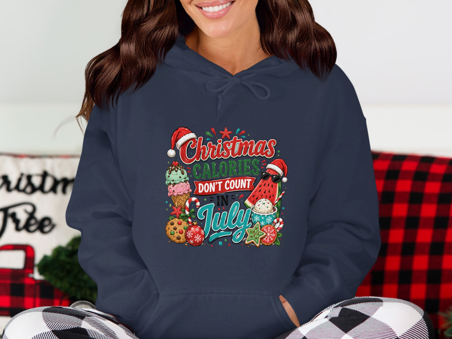 Navy hoodie with "Christmas Calories Don't Count In July" graphic featuring festive treats.