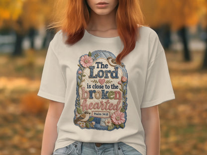 White t-shirt with "The Lord is close to the brokenhearted" and Psalm 34:18.