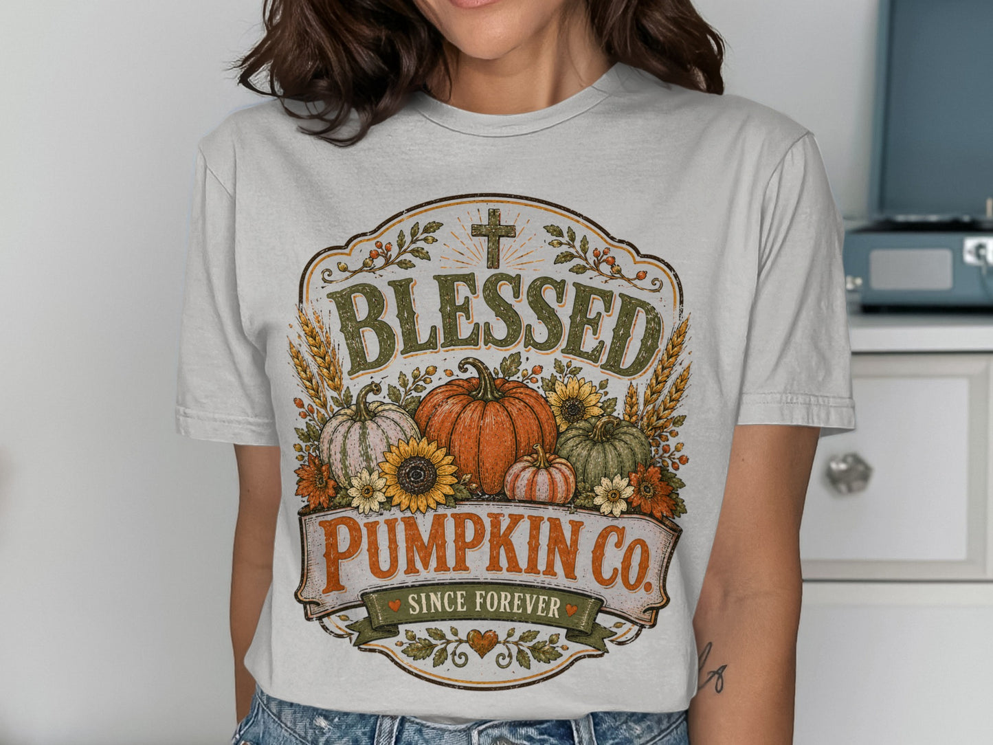T-shirt with "Blessed Pumpkin Co." graphic featuring pumpkins, sunflowers, wheat, and a cross.