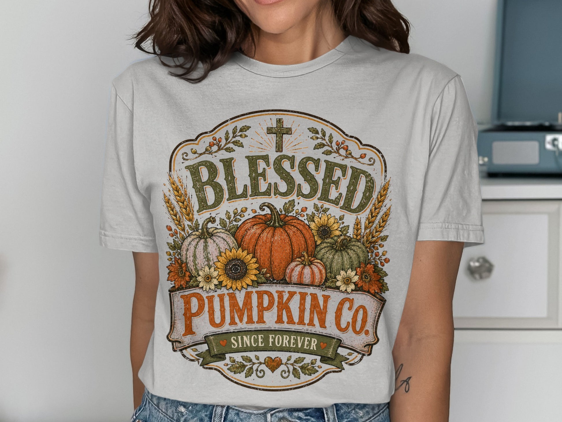 T-shirt with "Blessed Pumpkin Co." graphic featuring pumpkins, sunflowers, wheat, and a cross.