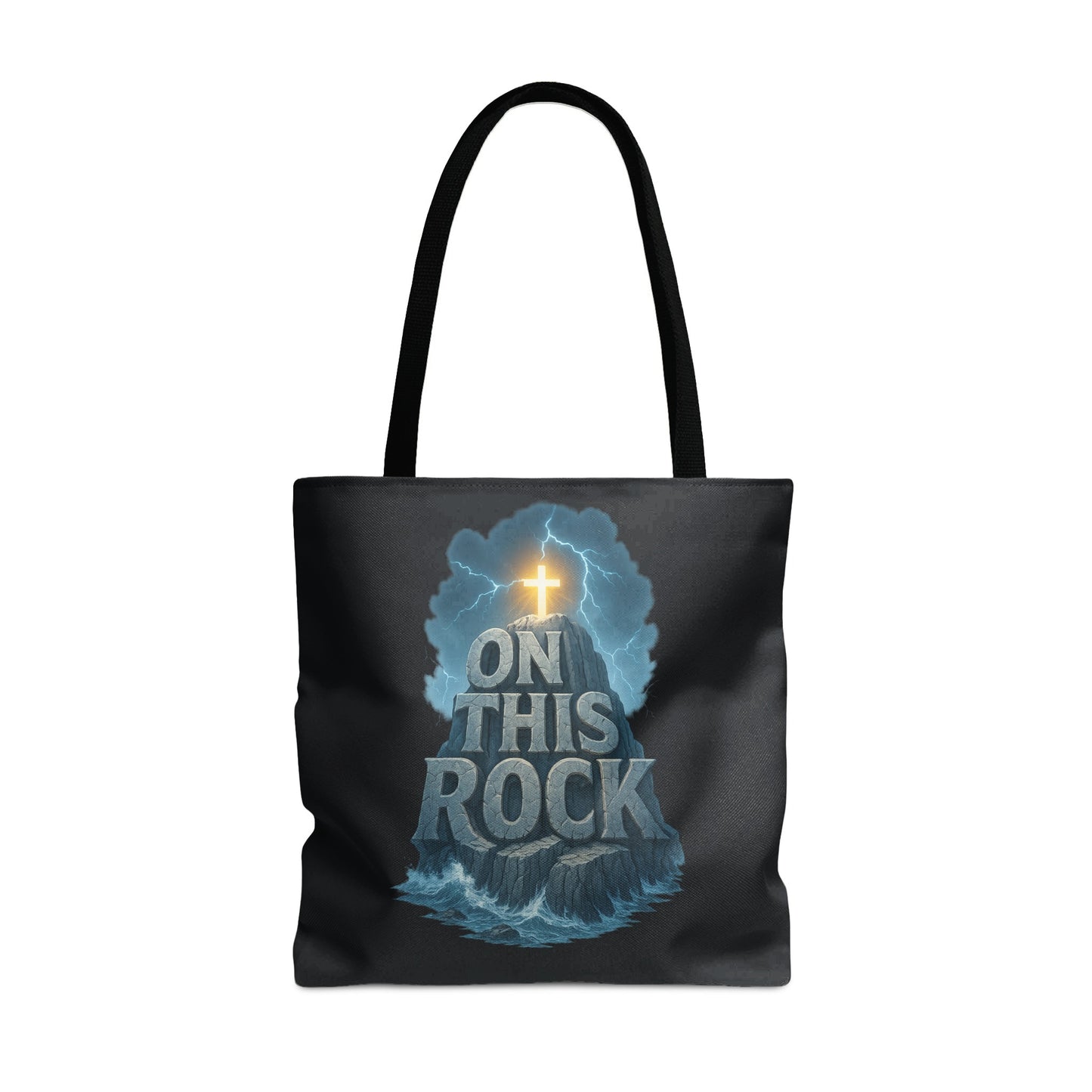 Black tote bag with the phrase "ON THIS ROCK" over a rock formation and cross.