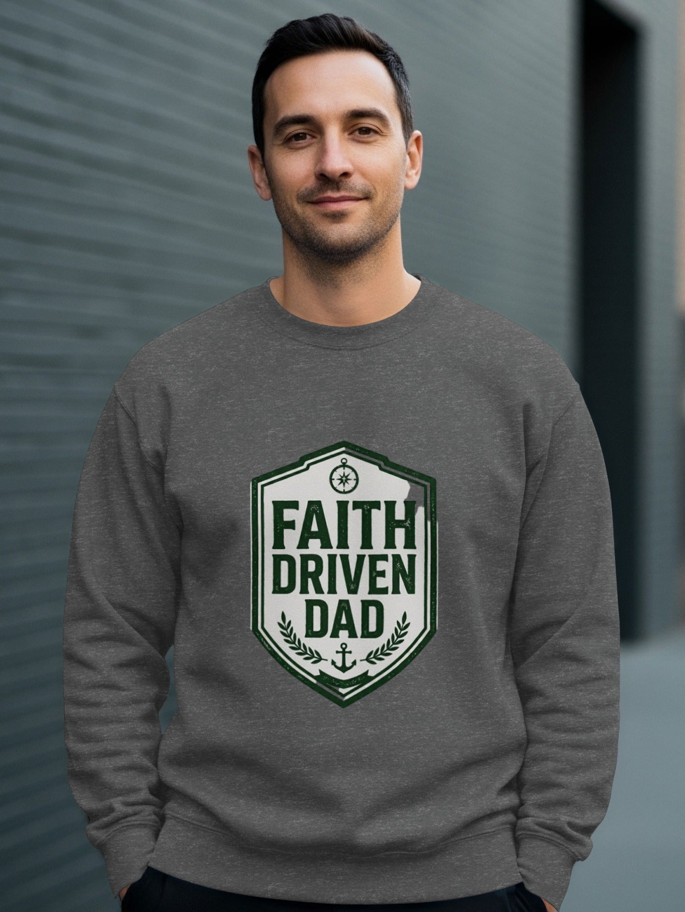 Man wearing a dark gray crewneck sweatshirt with "Faith Driven Dad" logo.