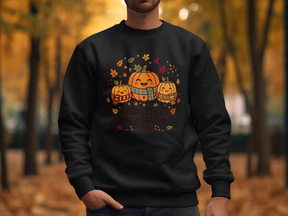 Black sweatshirt with pumpkins, leaves, and "Jesus loves pumpkin season too" text.