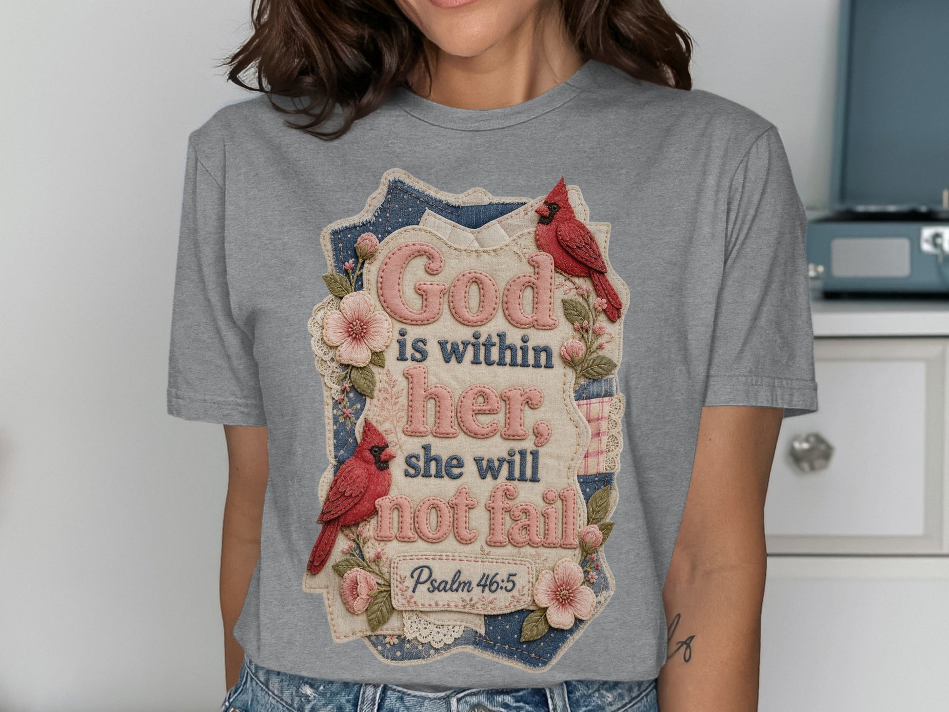 Gray t-shirt with cardinal birds and floral design, text "God is within her, she will not fail".