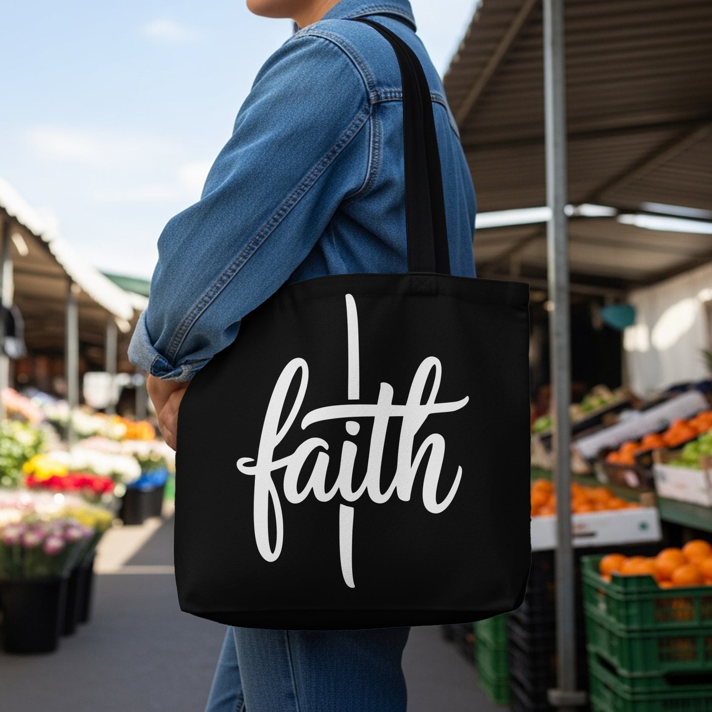 Black tote bag with white "faith" text and a vertical line.