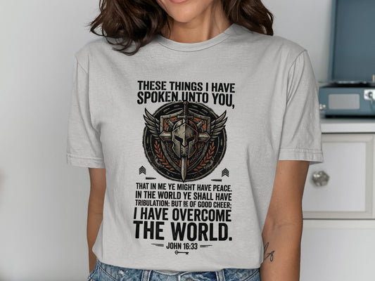 T-shirt with a shield graphic and the Bible verse John 16:33.