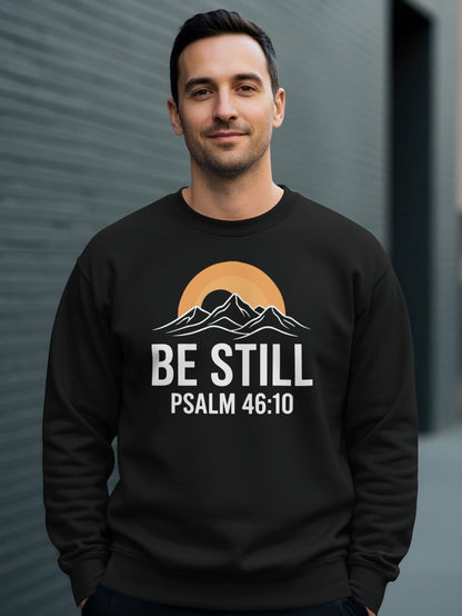 Black sweatshirt with "BE STILL PSALM 46:10" and mountain sunset graphic.