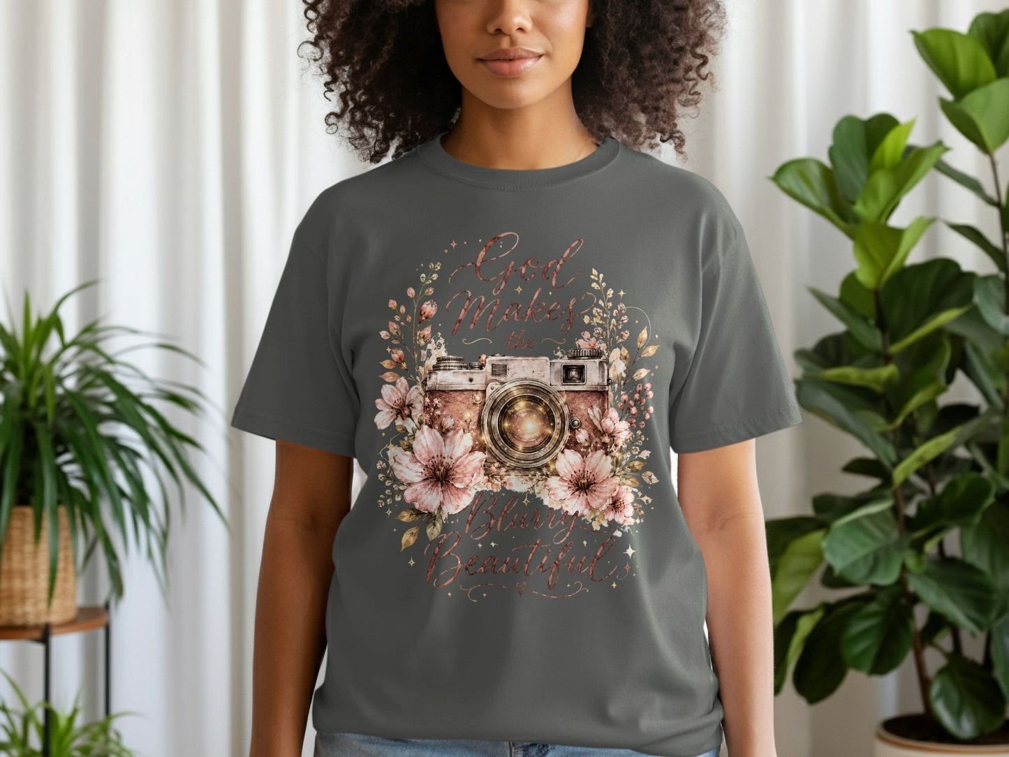 Dark grey t-shirt with floral camera graphic and text "God Makes the Blurry Beautiful."