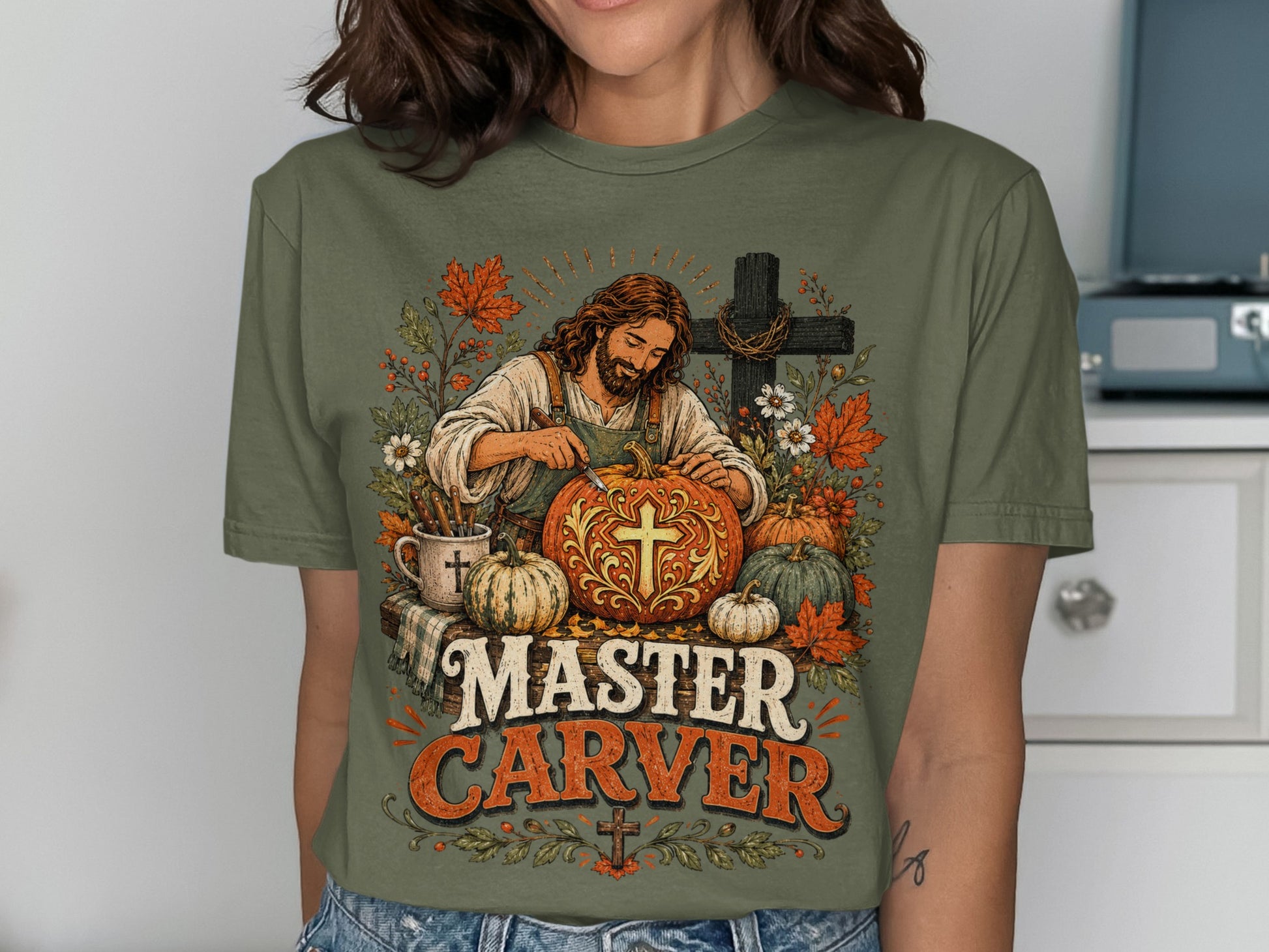 Jesus carving a pumpkin with "Master Carver" text and autumn foliage.