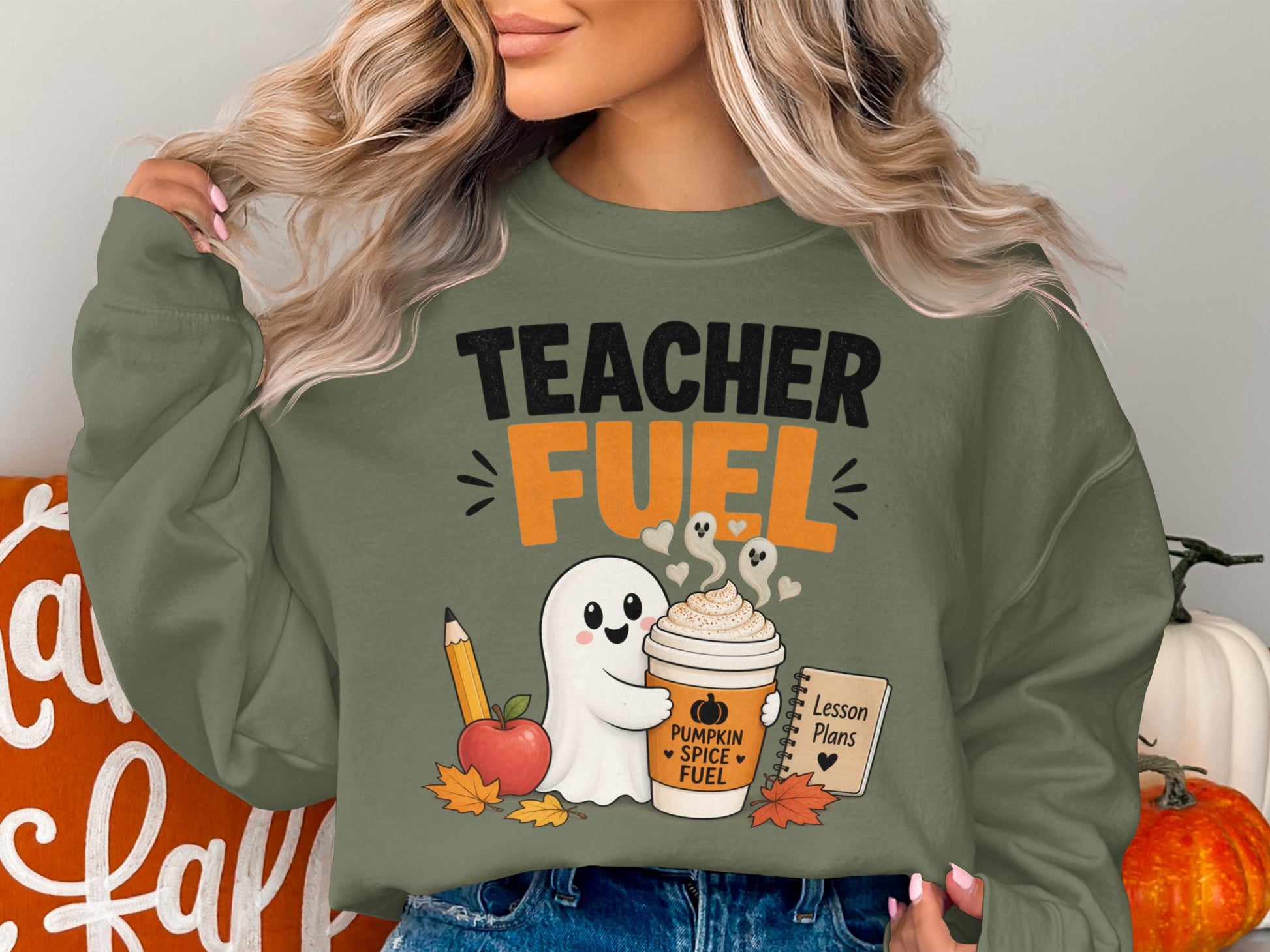 Green sweatshirt with "TEACHER FUEL" text and a ghost holding a coffee cup.