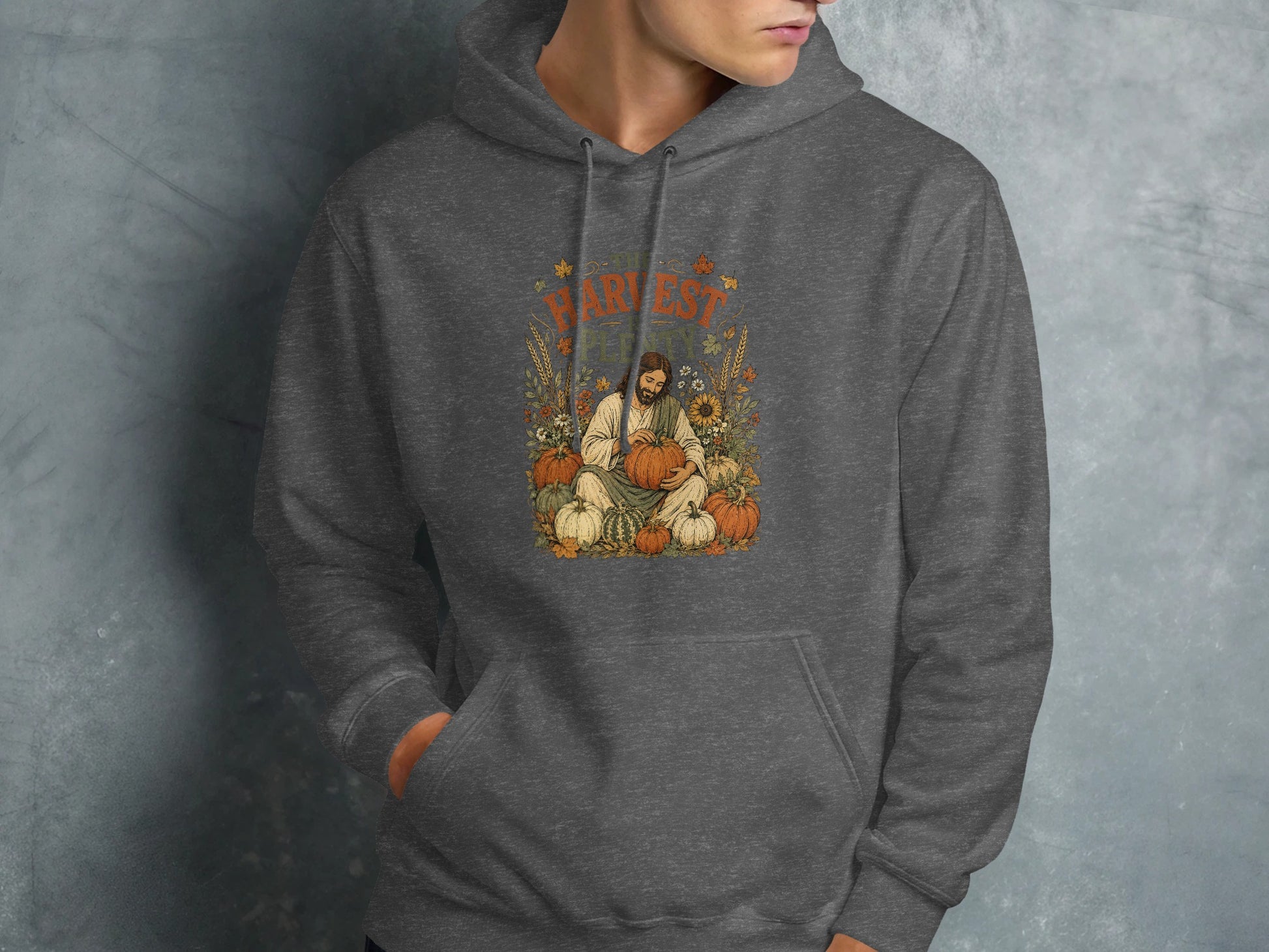 Dark gray hoodie featuring "Harvest Fest" text and Jesus with pumpkins graphic.
