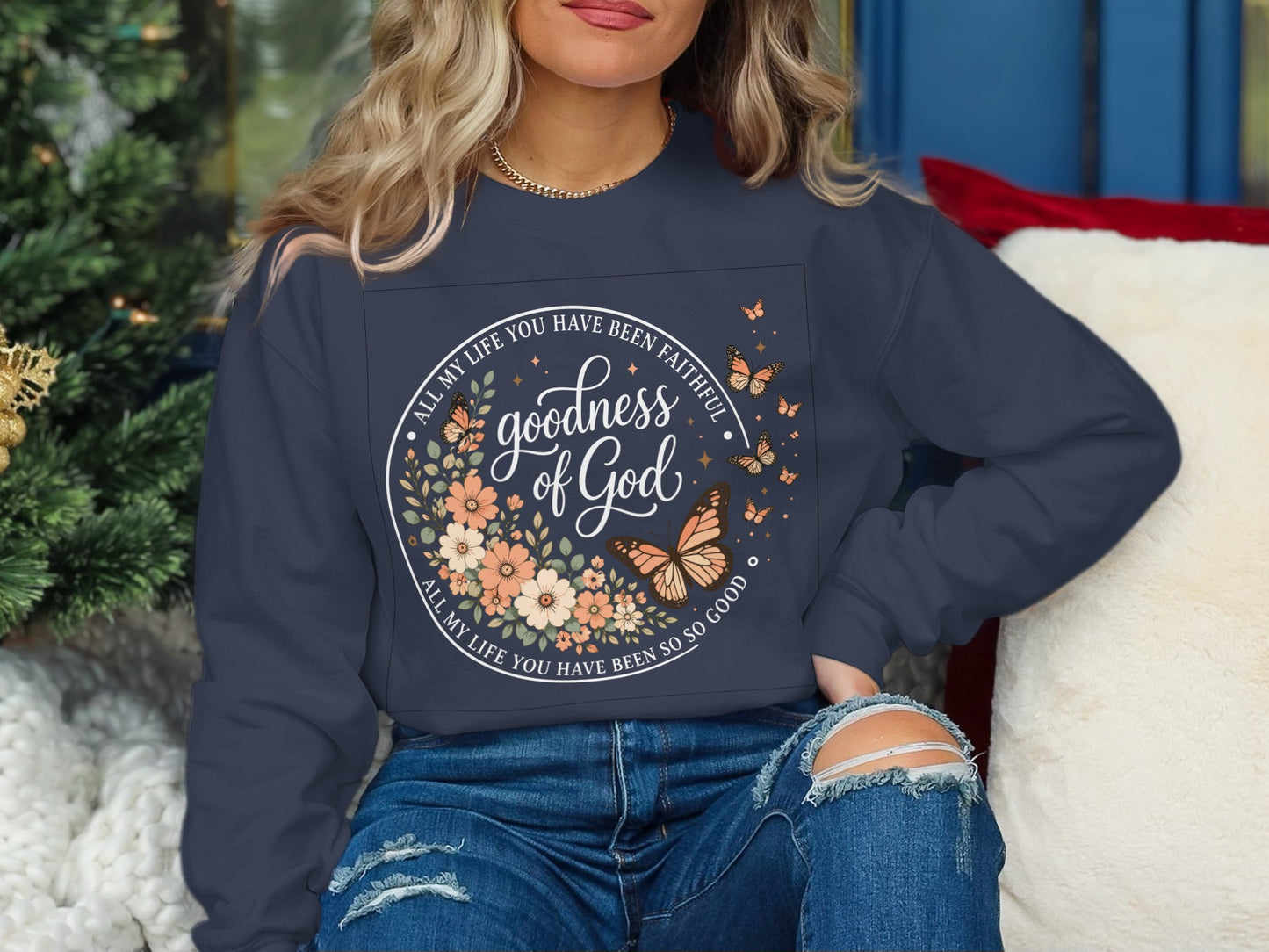 Dark sweatshirt with "goodness of God" floral and butterfly design.