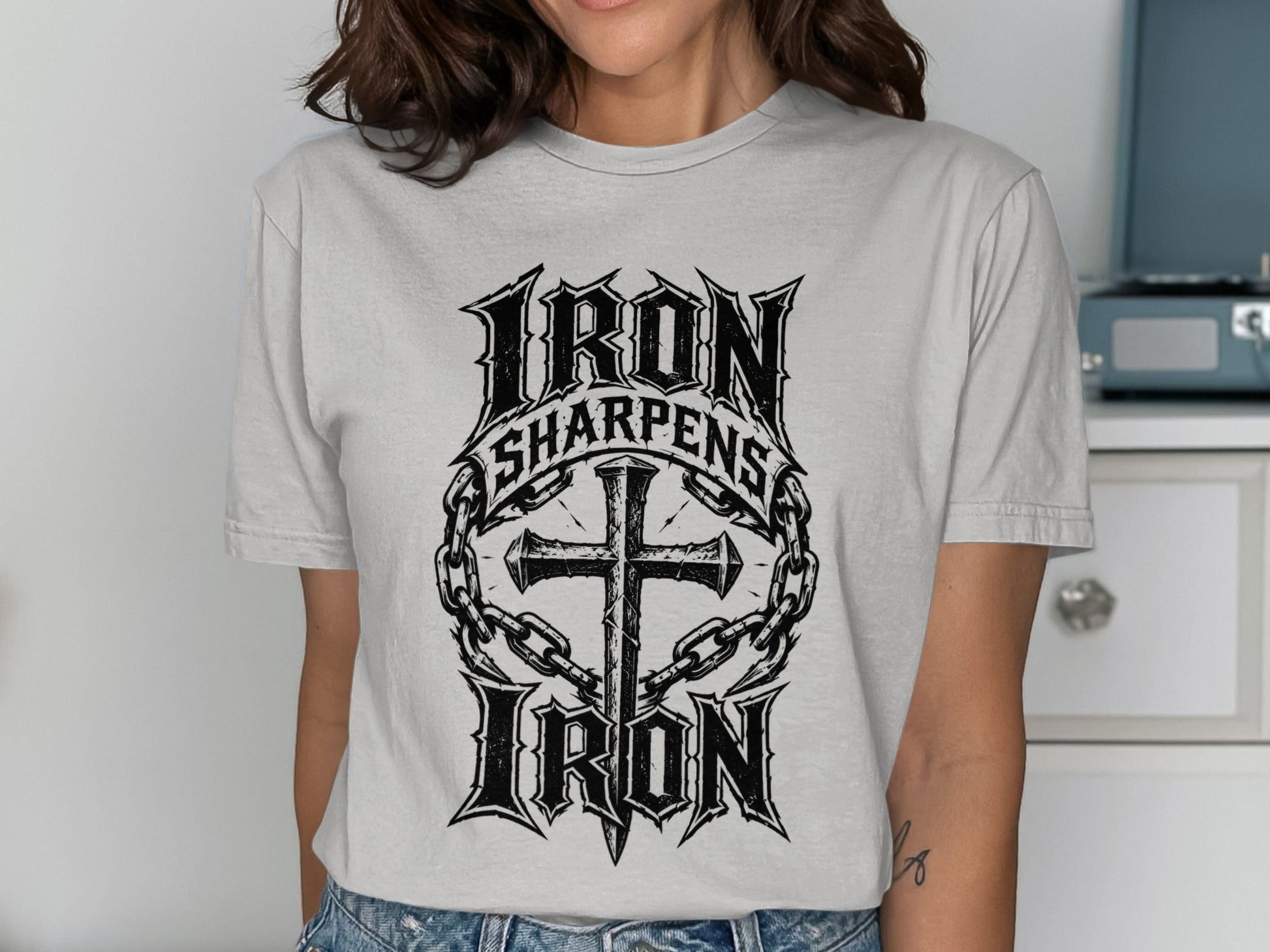 Cross with chains and "Iron Sharpens Iron" text on a t-shirt.