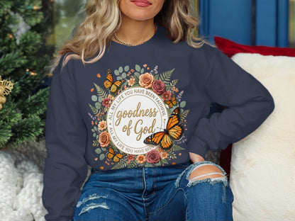 Dark blue sweatshirt with "Goodness of God" and Bible verse in a floral circle.