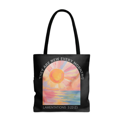 Black tote bag with sunrise art and text "LAMENTATIONS 3:22-23".