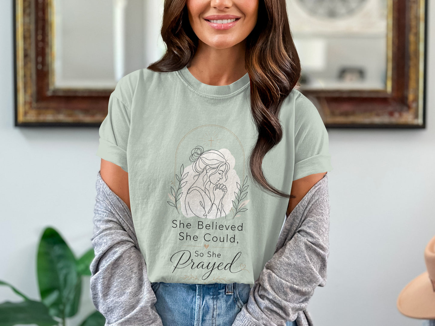 Light green t-shirt with graphic text "She Believed She Could, So She Prayed".
