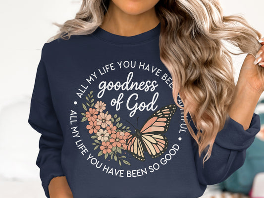 Navy sweatshirt with butterfly, flowers, and "goodness of God" text.
