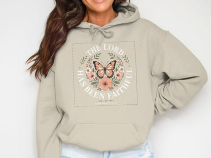 Cream hoodie with "The Lord has been faithful" text and floral butterfly graphic.