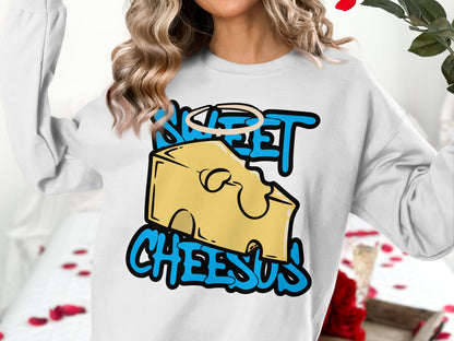 White sweatshirt with "Sweet Cheesus" text and a cartoon cheese illustration.