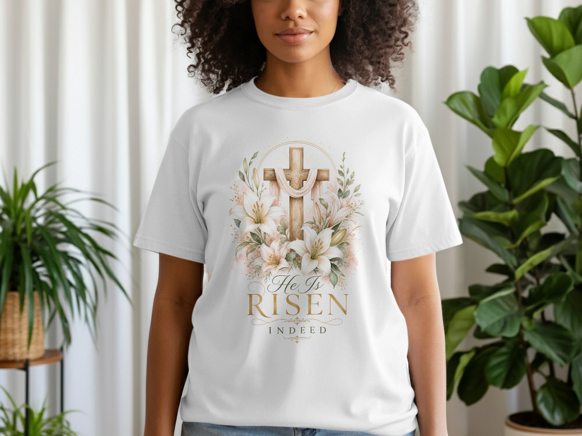 White t-shirt with a golden cross and lilies, reads "He Is RISEN Indeed".