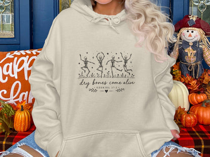 Cream hoodie with dancing skeletons and "dry bones come alive Ezekiel 37:5" text.