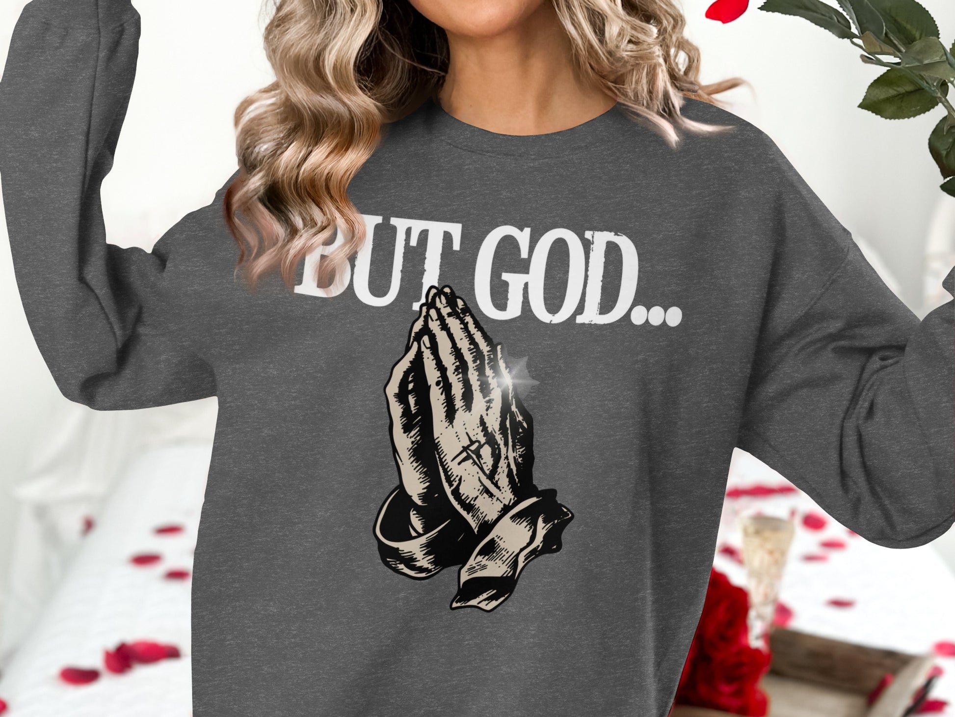 Dark gray sweatshirt with "BUT GOD..." and praying hands graphic.