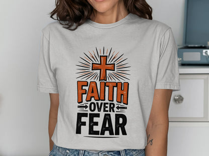 T-shirt with orange cross, "FAITH OVER FEAR" text, and sunburst graphic.