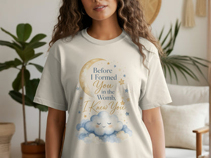 Cream t-shirt with text "Before I Formed You in the Womb, I Knew You" and celestial graphics.