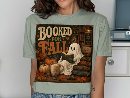 Booked for Fall graphic with a ghost reading on books and autumn elements.