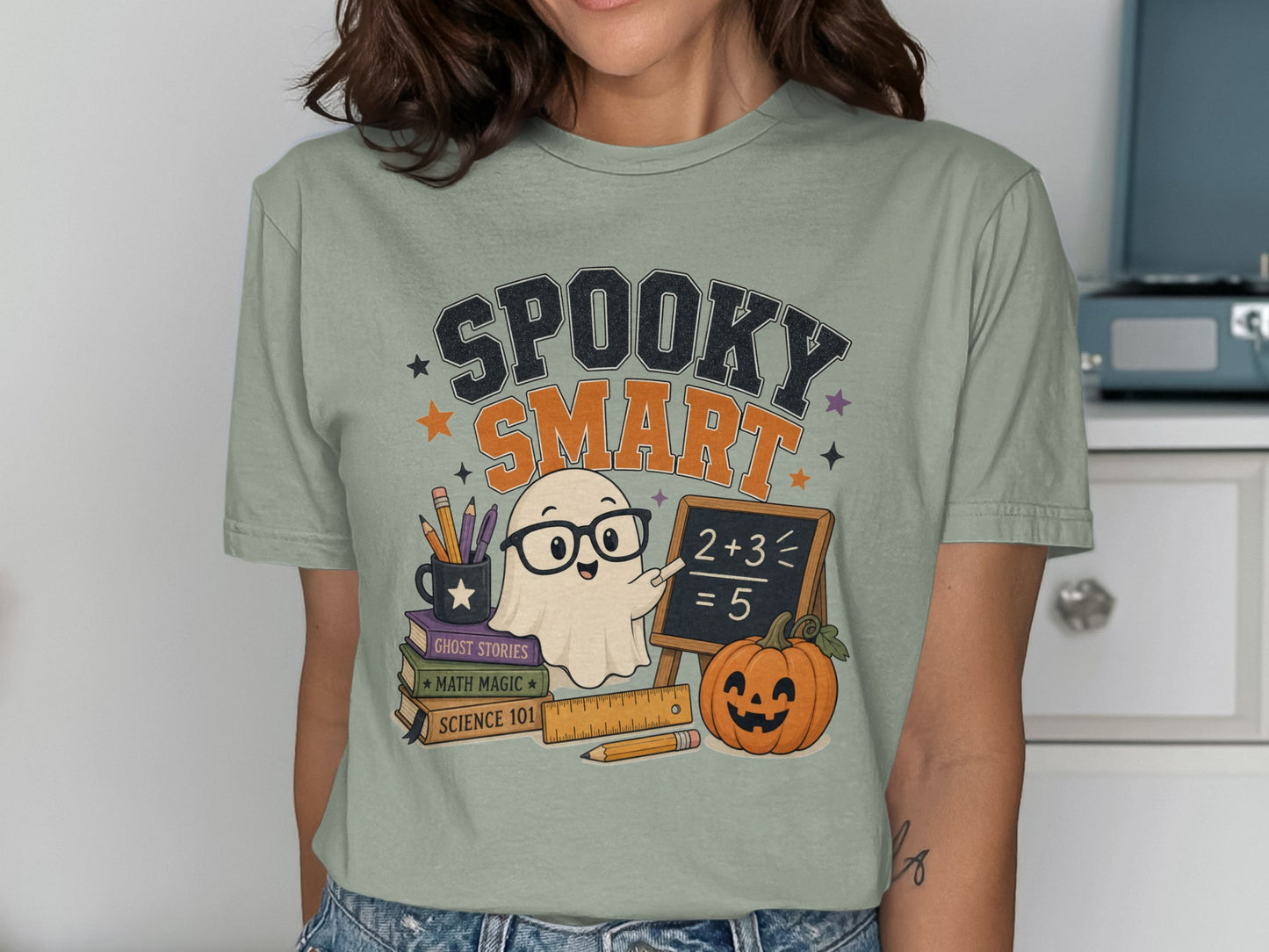 Ghost character with glasses and chalkboard on a light green shirt with "Spooky Smart" text.