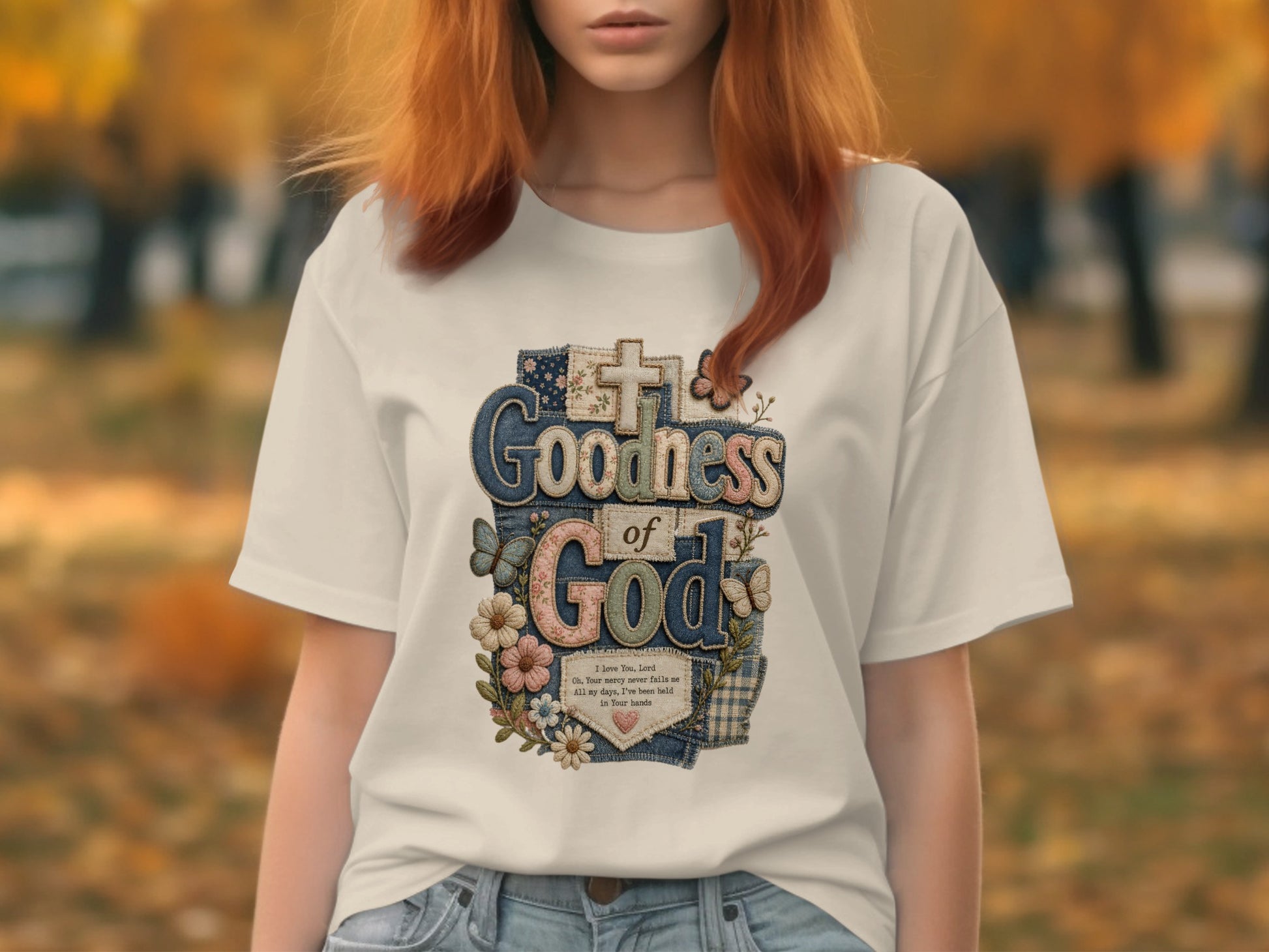 T-shirt with "Goodness of God" text and floral design.