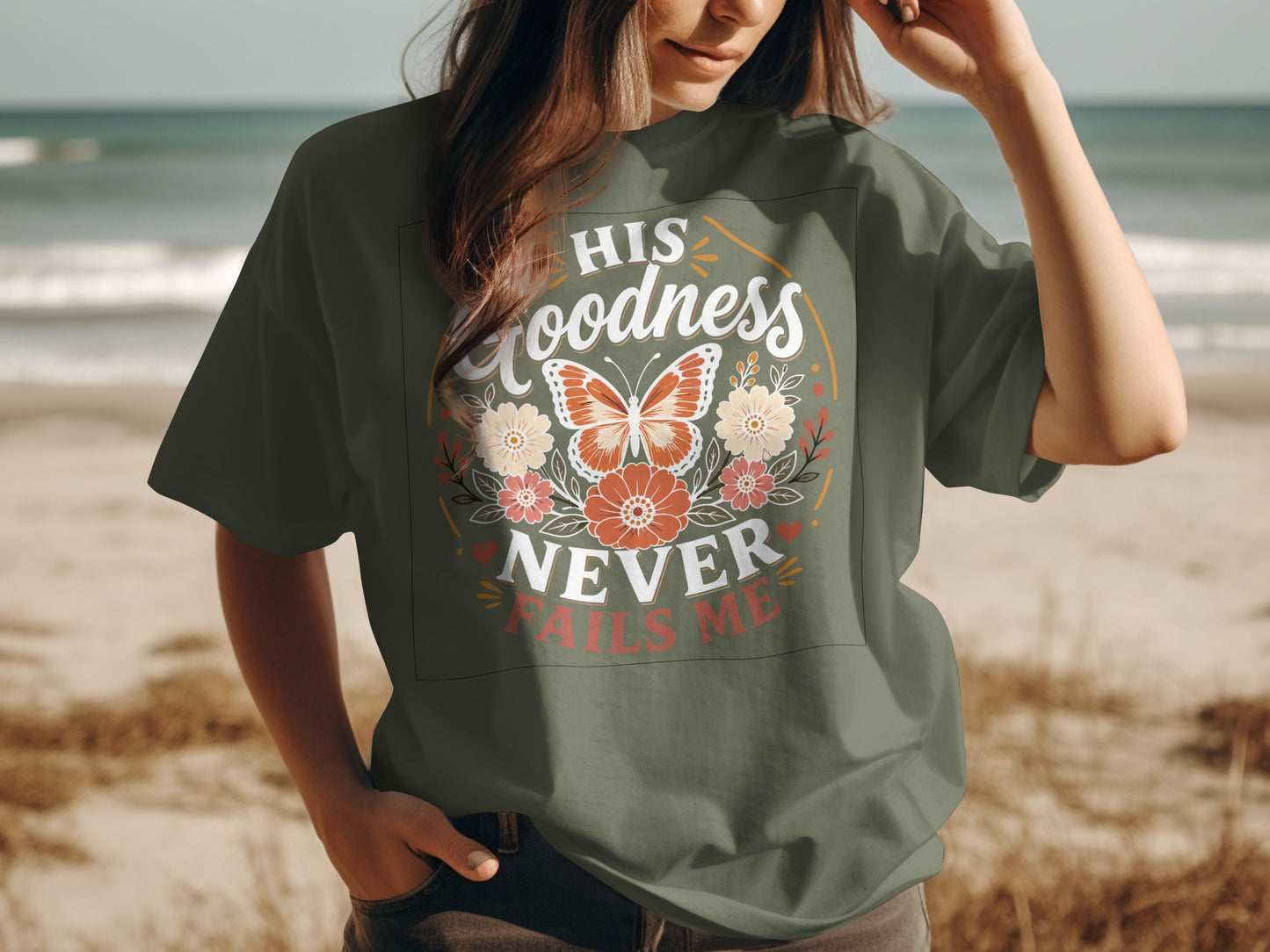 Green t-shirt with butterfly, floral design, and "HIS goodness NEVER FAILS ME" text.