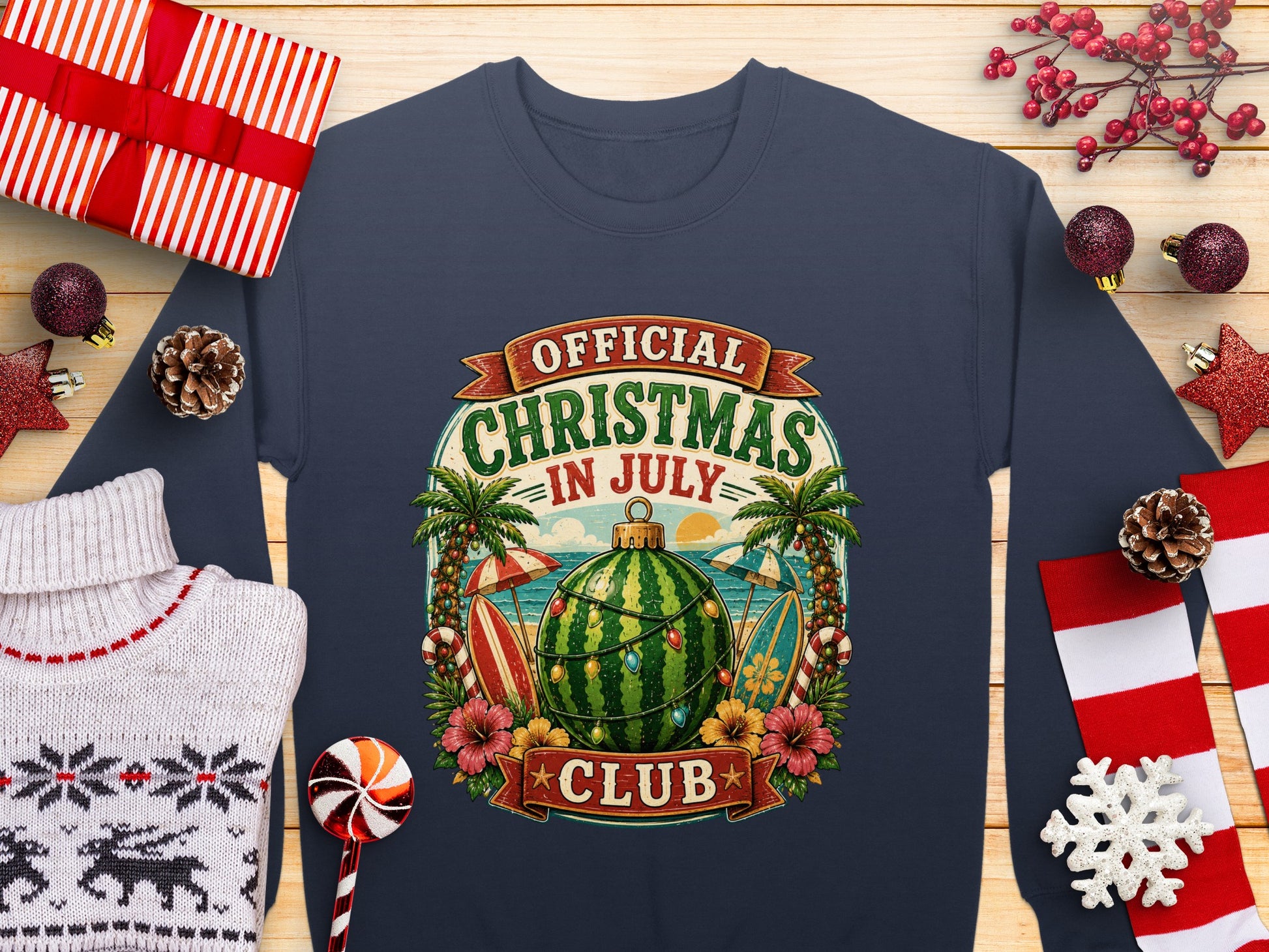 Sweatshirt with "Official Christmas in July Club" text, palm trees, watermelon, and surfboard.